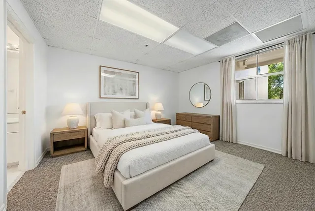 a bedroom with bed and a window