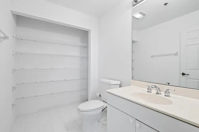 a bathroom with a sink a toilet and vanity