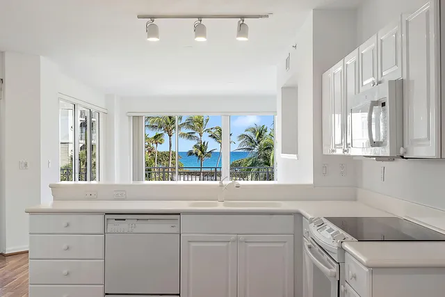 a kitchen with a sink and large window