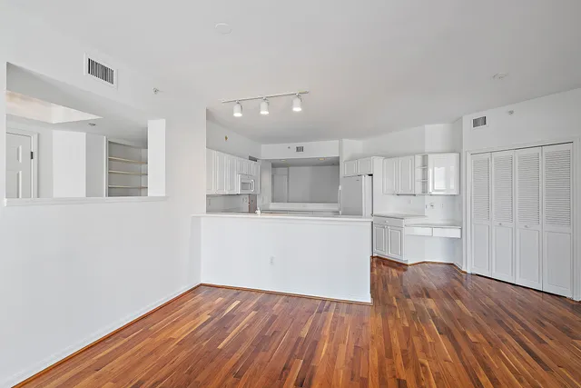 a view of kitchen with wooden floor and electronic appliances