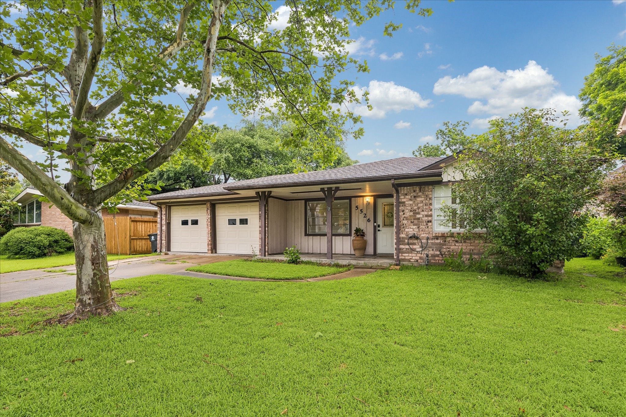 5526 Grape Street Houston, TX 77096 - Photo 1 of 10 a view of a house with a yard and sitting area