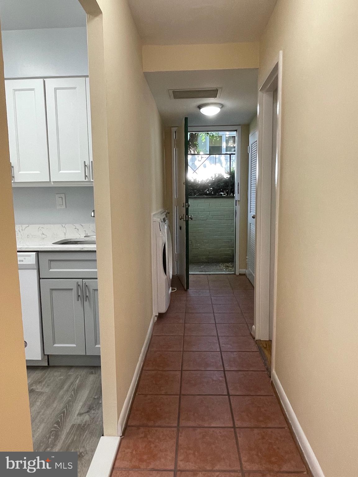 817 Delaware Avenue Southwest, Unit 227 Washington, DC 20024 - Photo 17 of 27 a view of a hallway with wooden floor and a kitchen