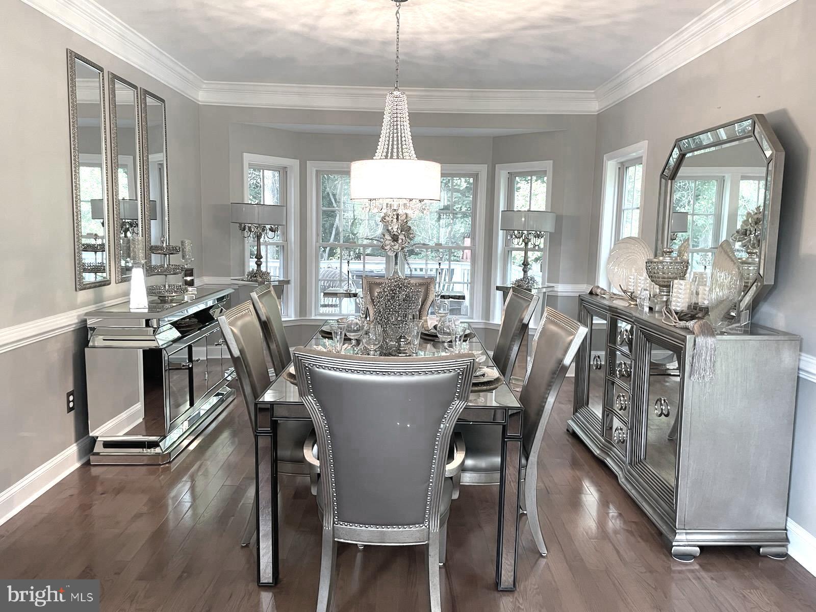 9319 Migan Road Randallstown, MD 21133 - Photo 5 of 32 a dining room with furniture a chandelier and wooden floor