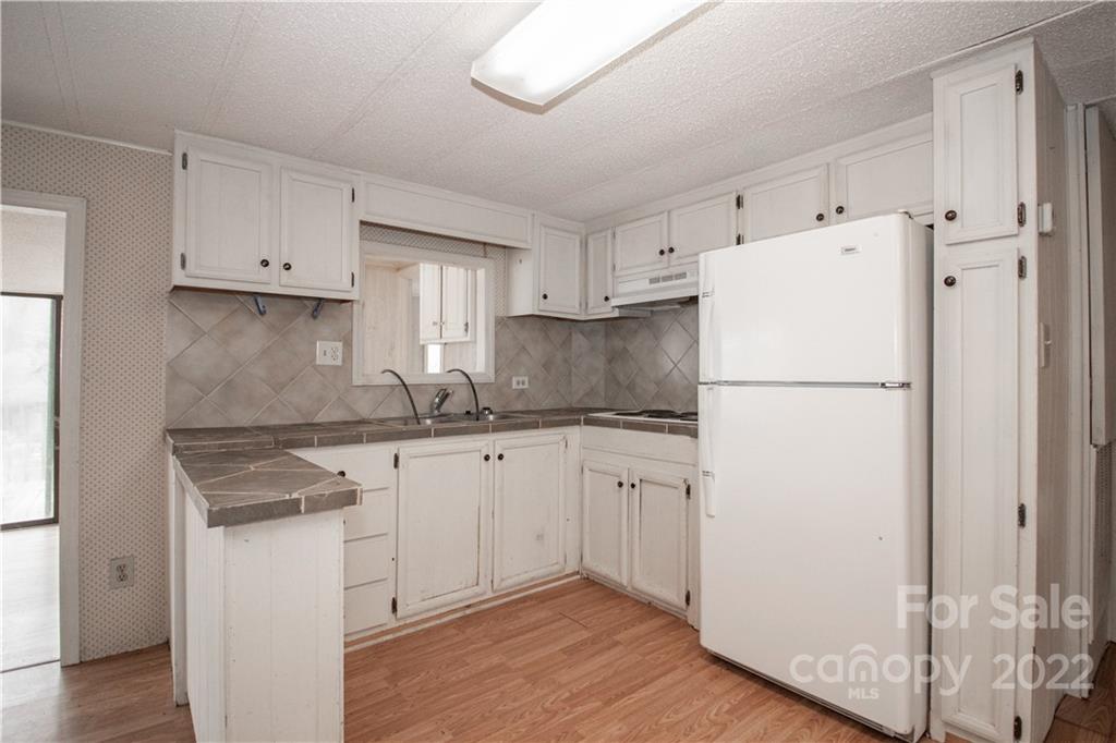 8785 Holdsclaw Road Terrell, NC 28682 - Photo 11 of 35 a white refrigerator freezer sitting inside of a kitchen