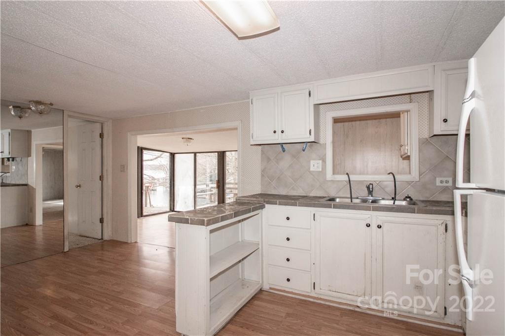 8785 Holdsclaw Road Terrell, NC 28682 - Photo 12 of 35 a kitchen with granite countertop a sink stove and cabinets