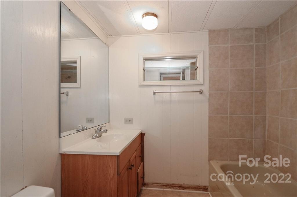 8785 Holdsclaw Road Terrell, NC 28682 - Photo 13 of 35 a bathroom with a sink a toilet and mirror