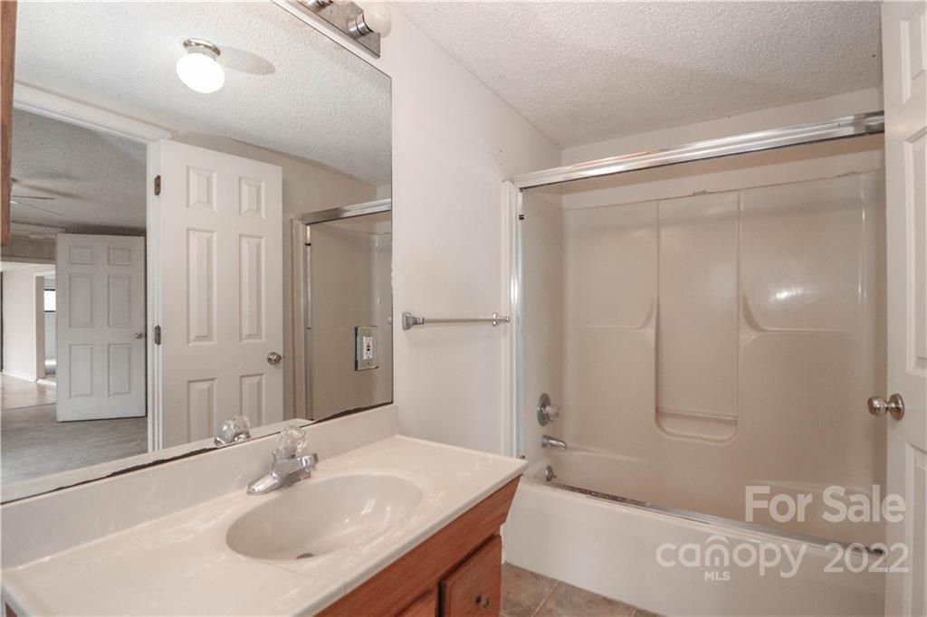 8785 Holdsclaw Road Terrell, NC 28682 - Photo 23 of 35 a bathroom with a sink shower and a mirror