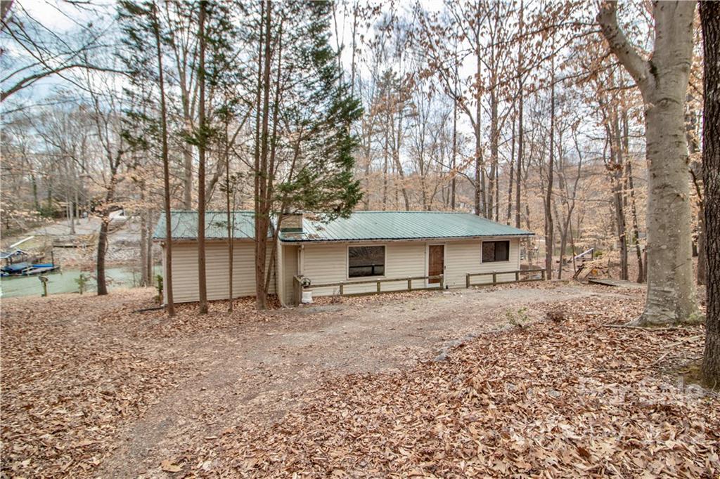 8785 Holdsclaw Road Terrell, NC 28682 - Photo 3 of 35 a big house with large trees and wooden fence