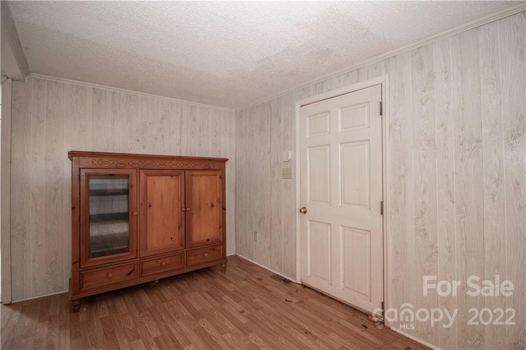 8785 Holdsclaw Road Terrell, NC 28682 - Photo 6 of 35 a view of an empty room with wooden floor and a door