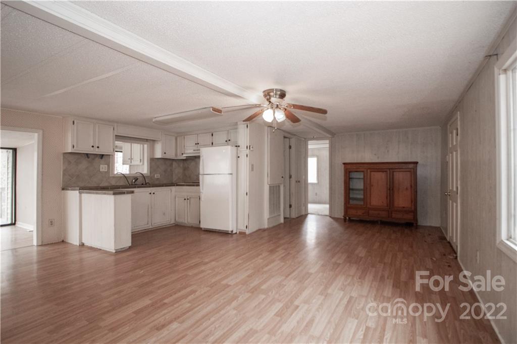 8785 Holdsclaw Road Terrell, NC 28682 - Photo 8 of 35 a view of empty room with wooden floor and window