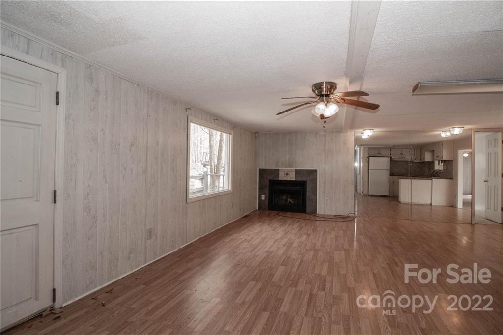 8785 Holdsclaw Road Terrell, NC 28682 - Photo 9 of 35 a view of an empty room with a fireplace and a window