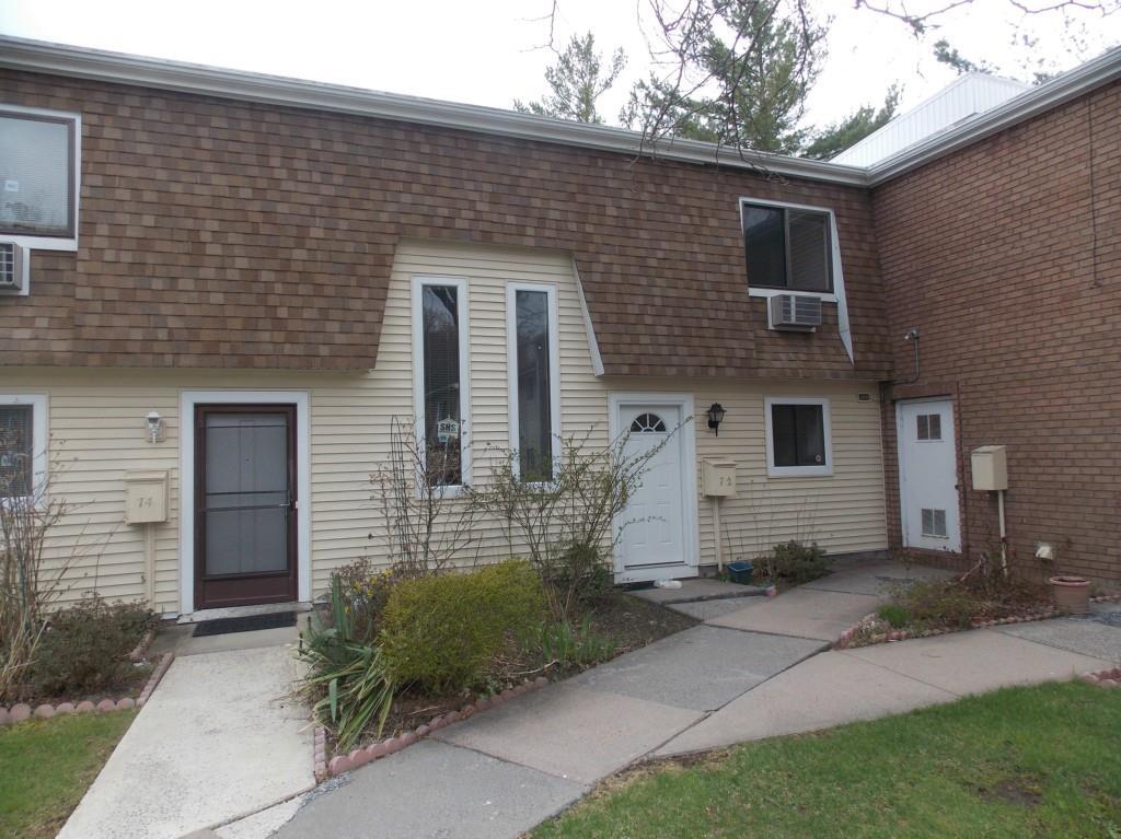 72 Sutton Place, Unit 72 Bloomfield, CT 06002 - Photo 1 of 1 a front view of a house with garden