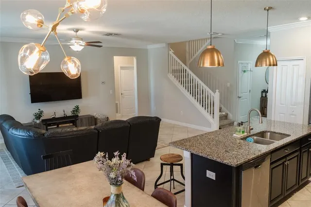 a kitchen with a table chairs and a flat screen tv