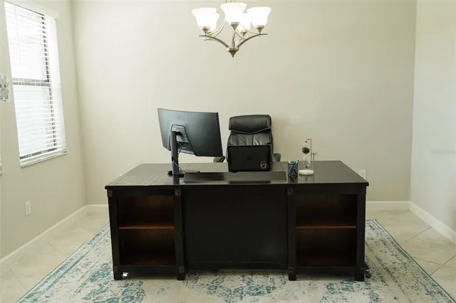 a room with a table chairs and wooden floor