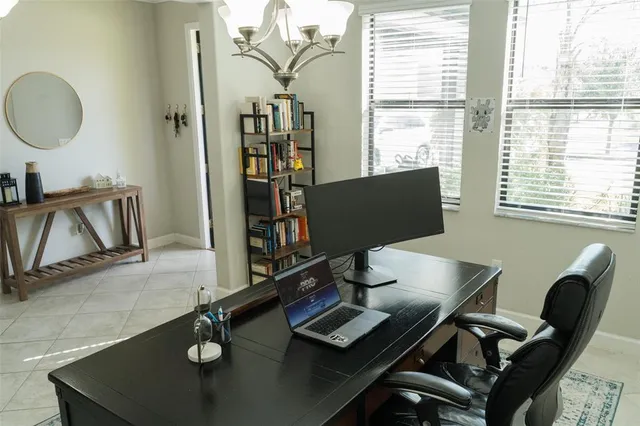 a view of a workspace with furniture and a window