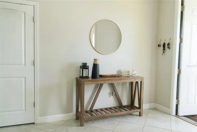 a room with a mirror and a wooden door