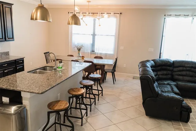 a dining room with furniture and a window