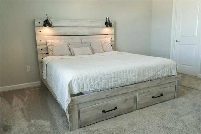 a bedroom with a bed and a night stand