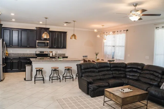 a living room with lots of furniture and kitchen view