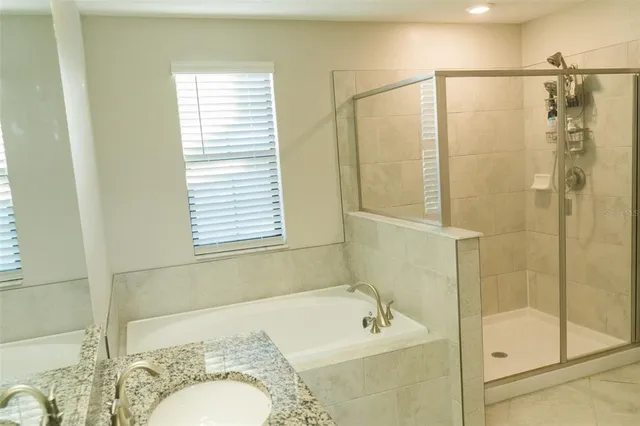 a bathroom with a bathtub and a shower