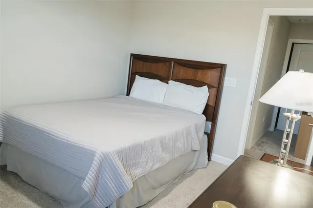 a bed sitting in a bedroom next to a window