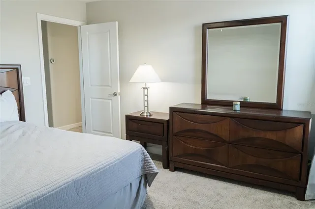 a bedroom with a bed and a dresser