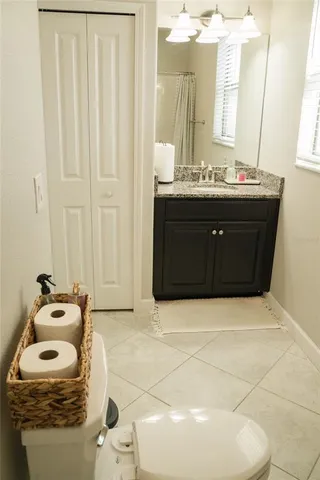 a bathroom with a sink a toilet and mirror