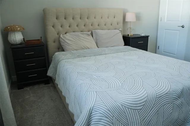 a bed room with a bed and a lamp