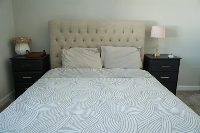 a bedroom with a bed and a night stand