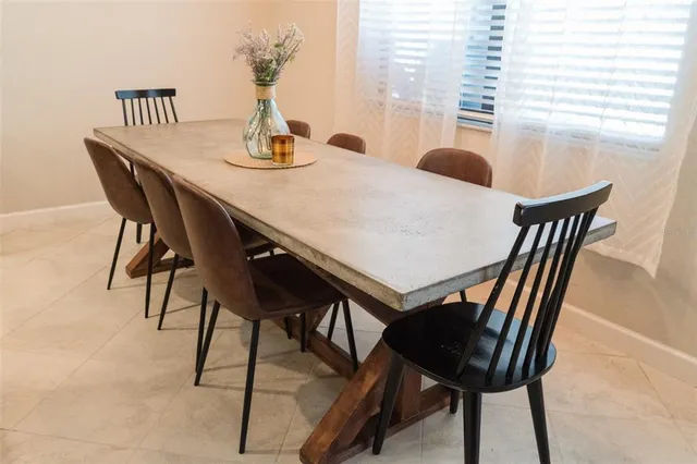 a dining room with furniture and window