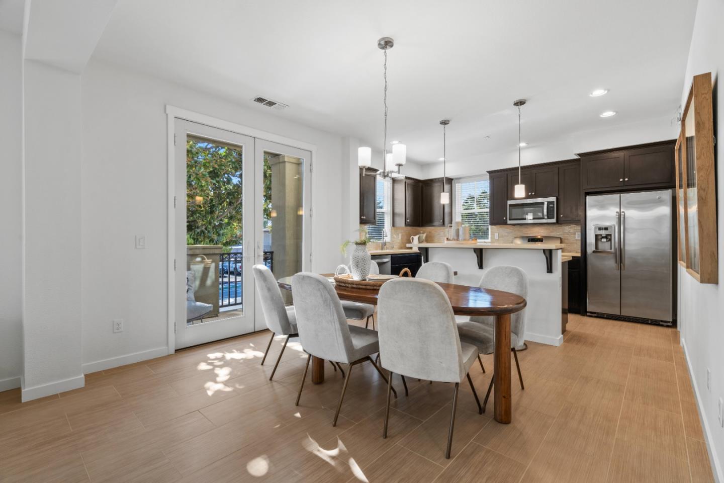 110 Calderon Avenue Mountain View, CA 94041 - Photo 8 of 25 a view of a dining room with furniture window and stainless steel appliances
