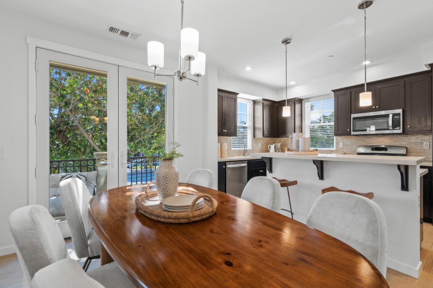 110 Calderon Avenue Mountain View, CA 94041 - Photo 9 of 25 a kitchen with stainless steel appliances granite countertop a stove a kitchen island a table and chairs