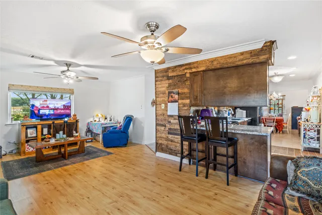 a dining room with furniture and wooden floor