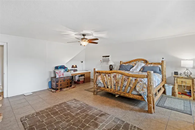 a bedroom with furniture and a window