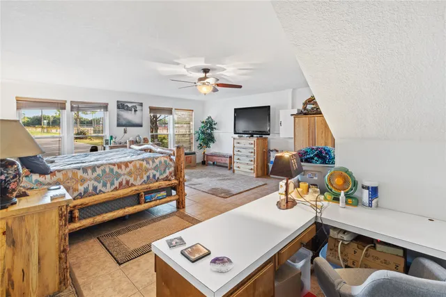 a bedroom with furniture and a window