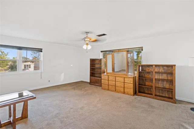 a view of a livingroom with furniture and natural light
