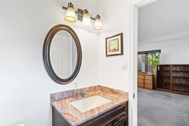 a bathroom with a sink a vanity and a mirror