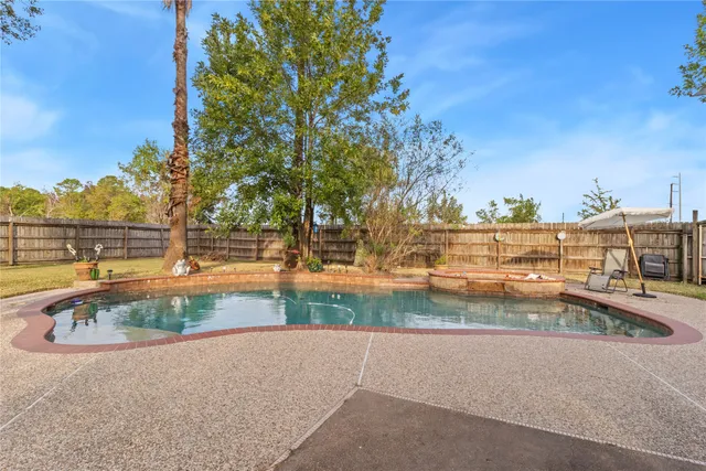 a view of a swimming pool with an outdoor seating and a garden