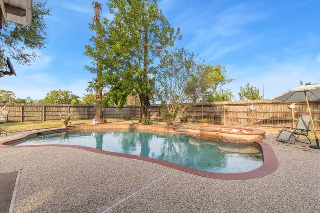 a view of a swimming pool with an outdoor seating