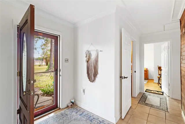 a view of a hallway with wooden floor and windows