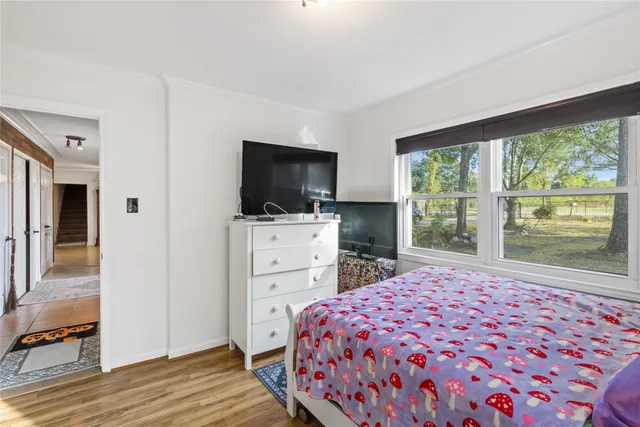 a bedroom with a bed and a television