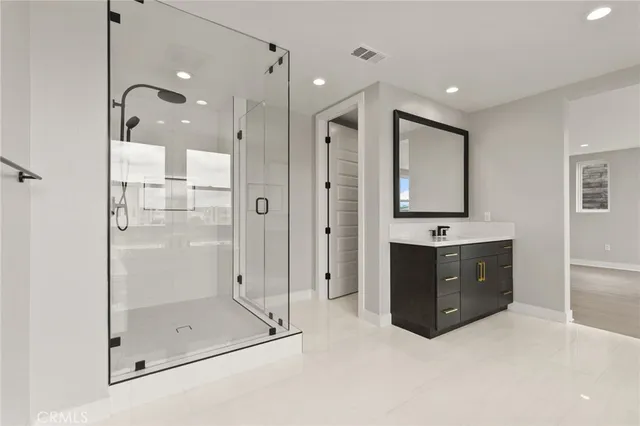 a bathroom with a shower sink and mirror