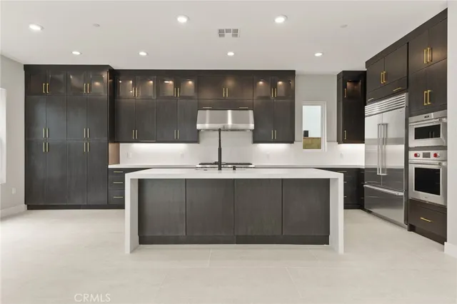 a kitchen with stainless steel appliances a refrigerator and a sink