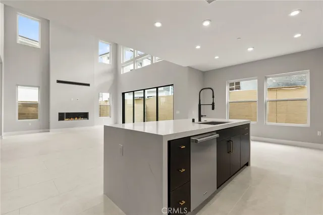 a large kitchen with stainless steel appliances granite countertop a sink and stove