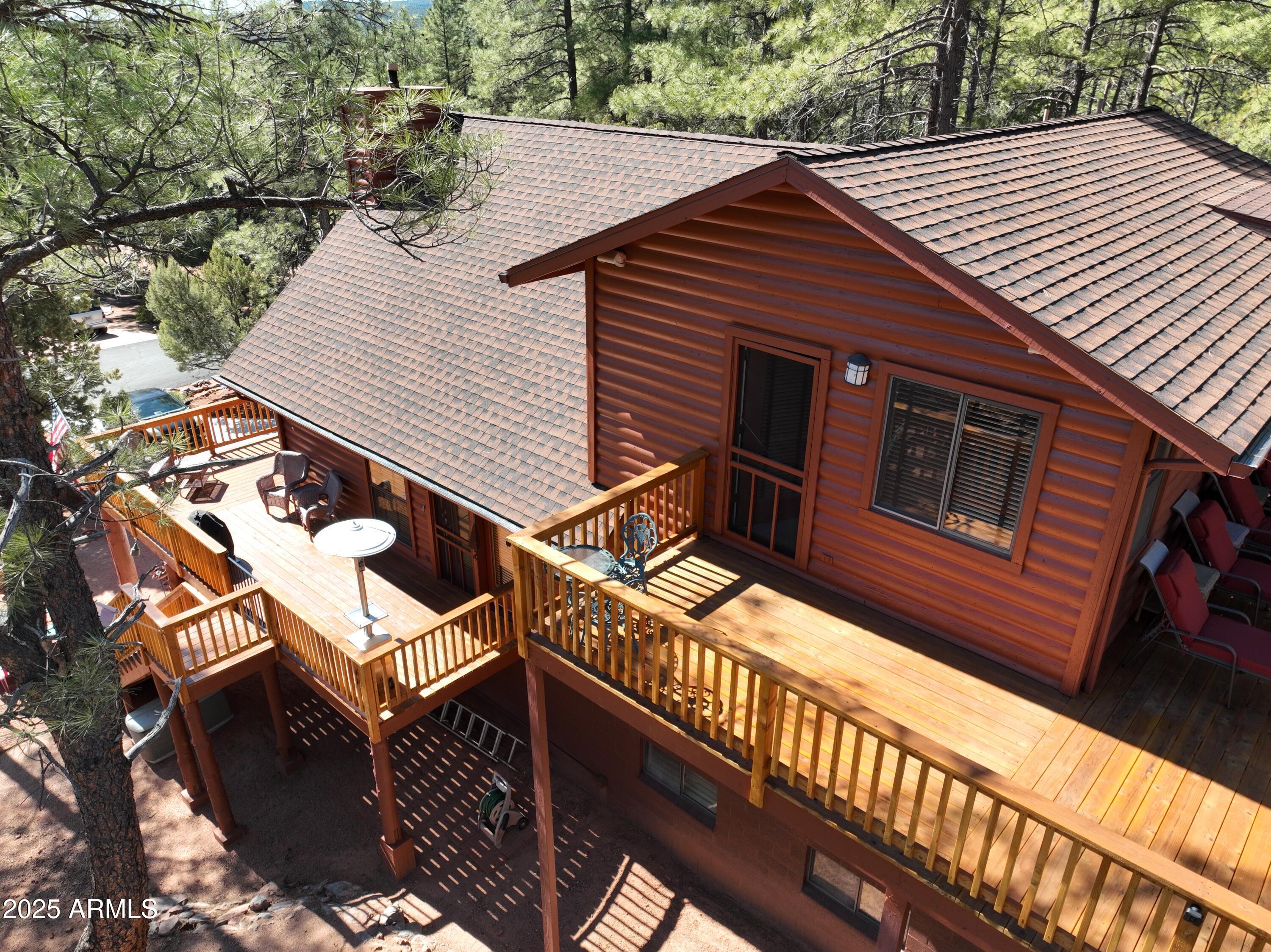 5579 Solitude Trail Loop Pine, AZ 85544 - Photo 4 of 50 a backyard of a house with wooden deck and furniture