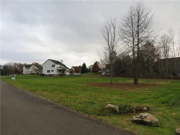a view of a field with houses