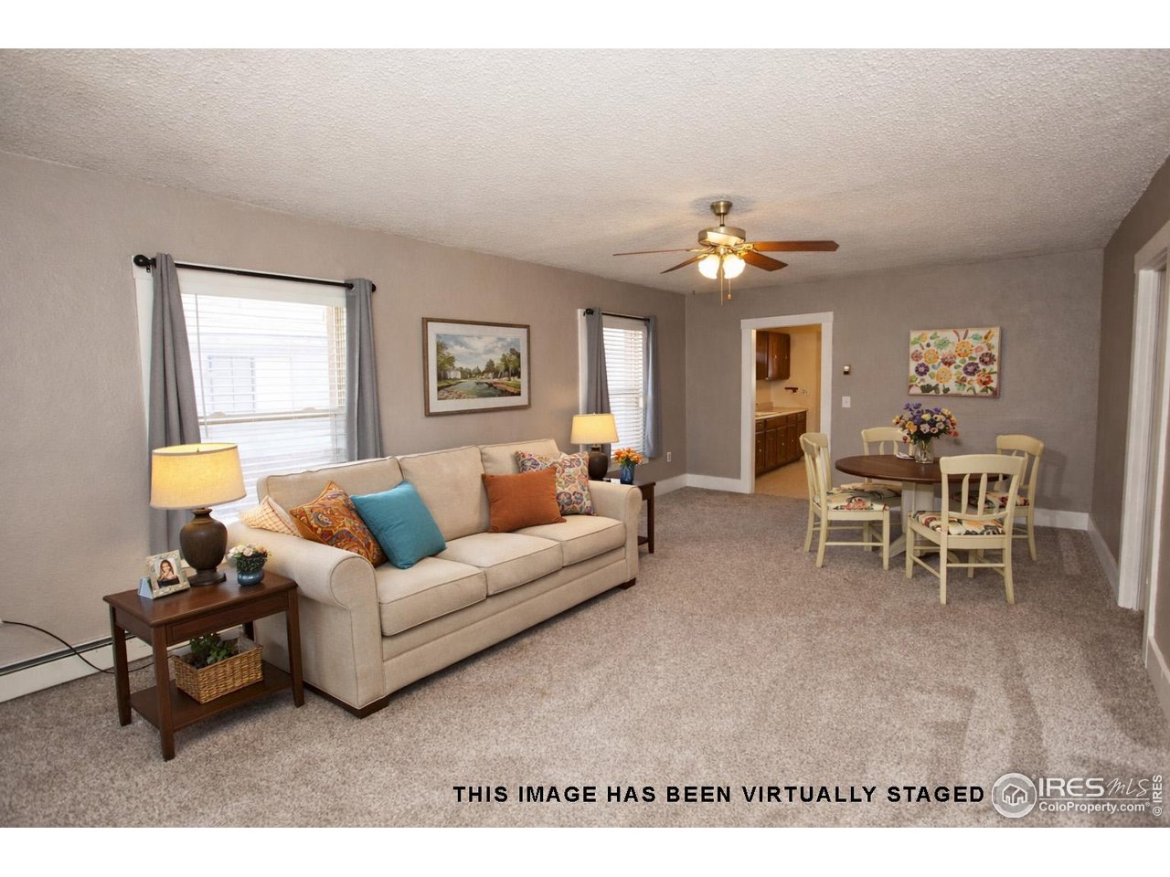 323 Cleveland Street Sterling, CO 80751 - Photo 4 of 28 a living room with furniture a chandelier and a window