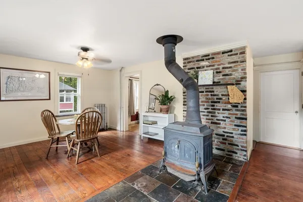 a view of a livingroom with furniture a chandelier and wooden floor
