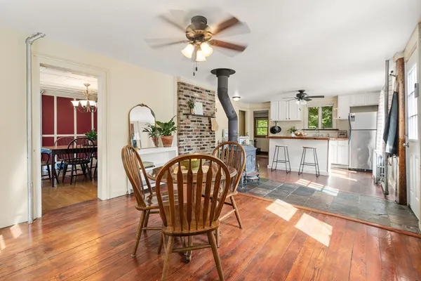 a dining room with furniture a chandelier and wooden floor