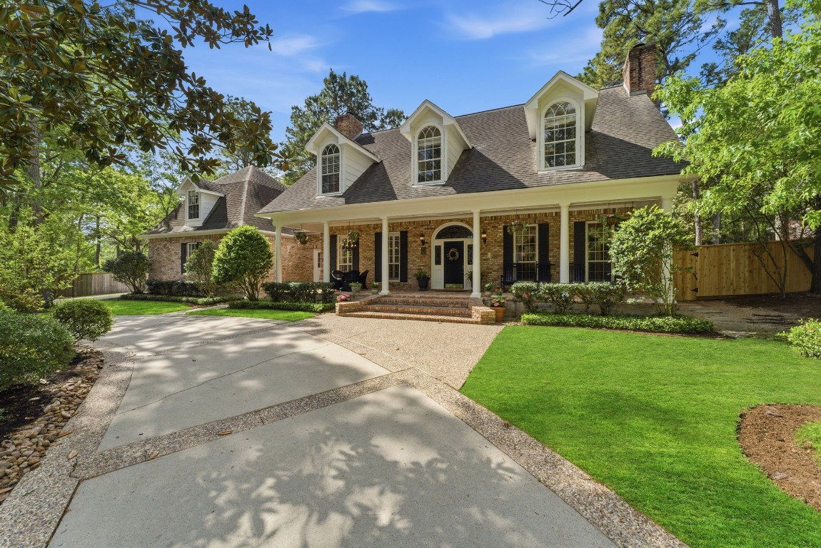 147 North Taylor Point Drive Spring, TX 77382 - Photo 3 of 44 This charming home boasts a welcoming front right side with a classic brick facade, elegant arched windows, and a cozy porch that invites you to relax and enjoy the serene surroundings.